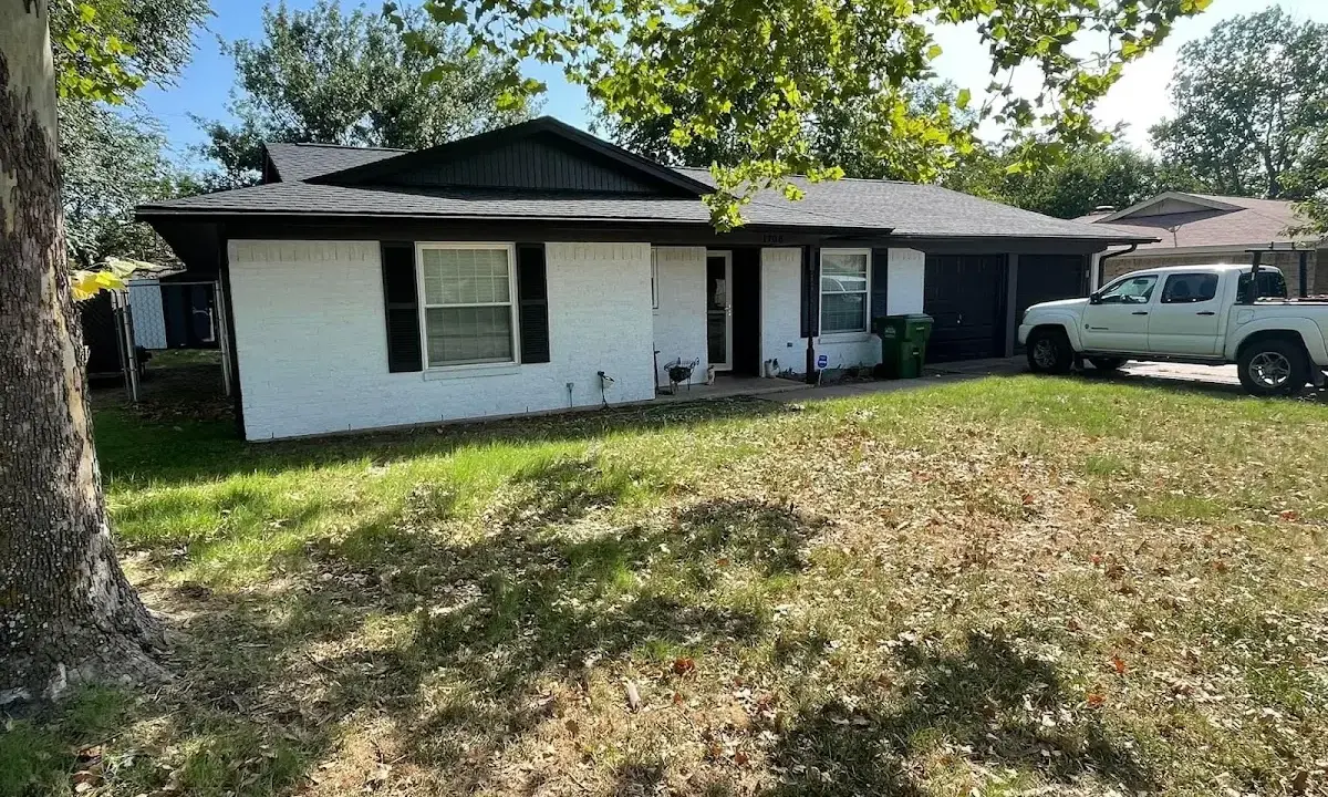Professional roofing crew working on a residential roof in Sinton
